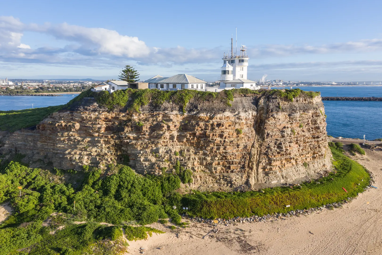 Nobbys Lighthouse at the mouth of the Hunter River , a Newcastle landmark visible from the city